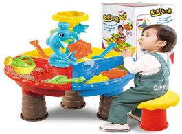 Foto van Speelgoed kids summer outdoor beach sandpit toy sand bucket water wheel table toys play children lea